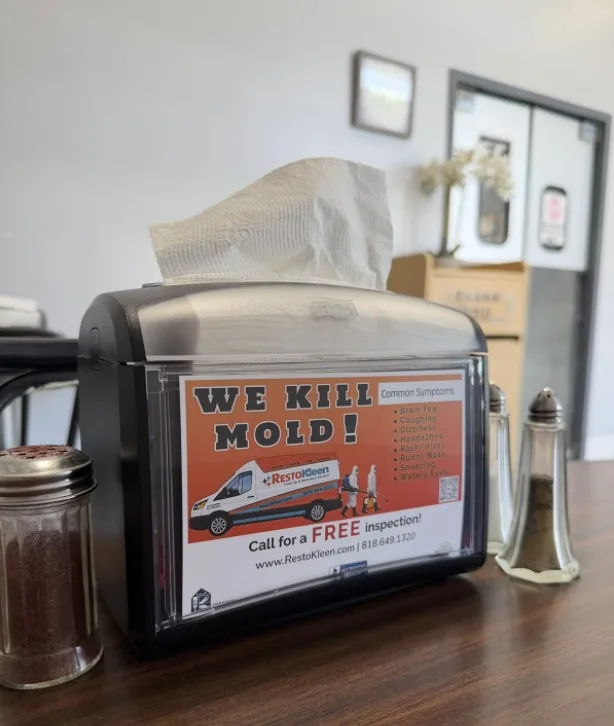 Restaurant table with a napkin dispenser, where sales reps sign up new locations